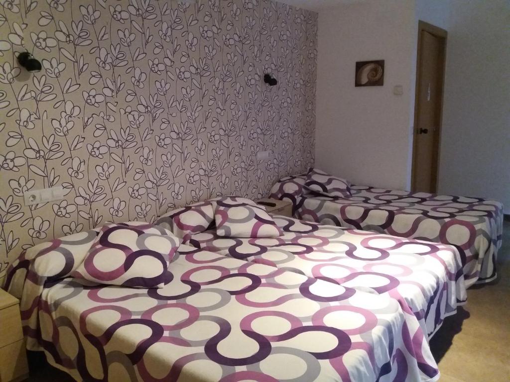 Postel nebo postele na pokoji v ubytování Hostal la Catedral