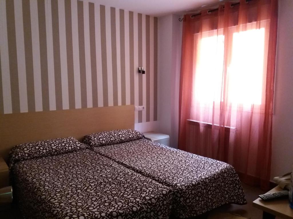 Postel nebo postele na pokoji v ubytování Hostal la Catedral