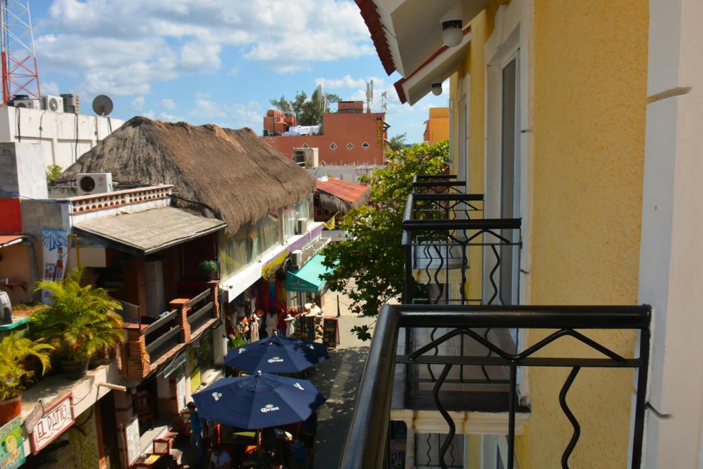 a view of a balcony with umbrellas on a building at Suites Los Arcos in Isla Mujeres