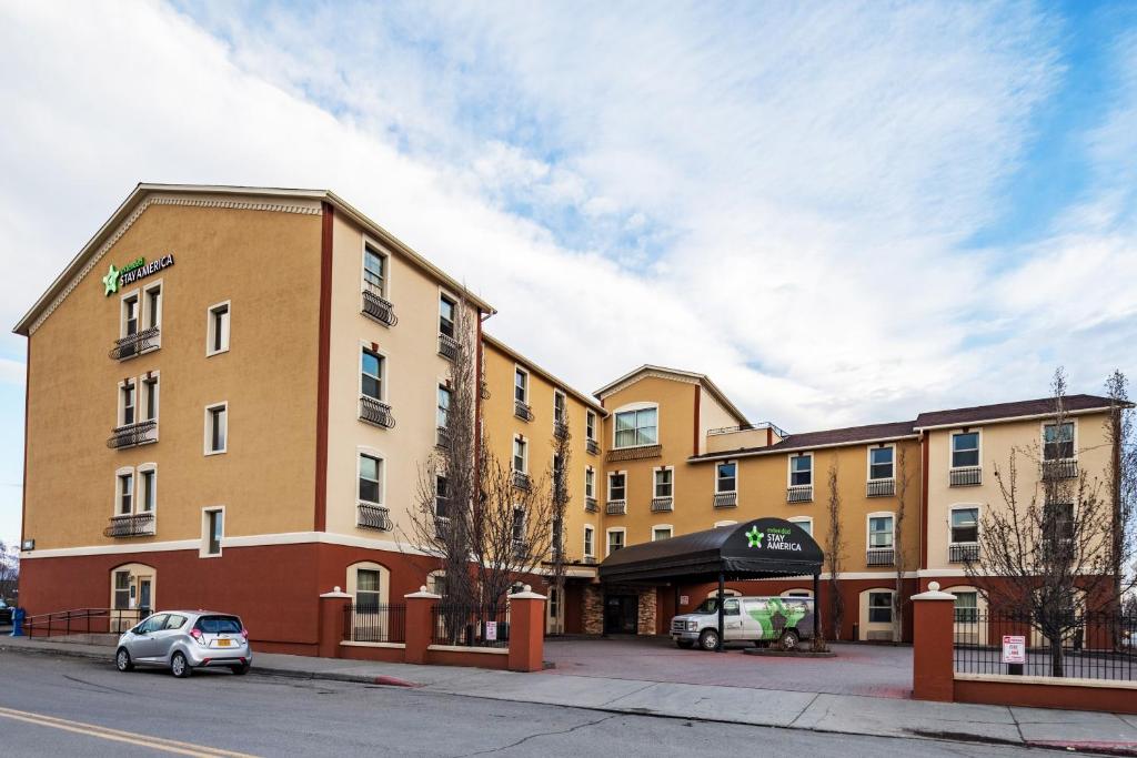 a building with a car parked in front of it at Extended Stay America Suites - Anchorage - Downtown in Anchorage