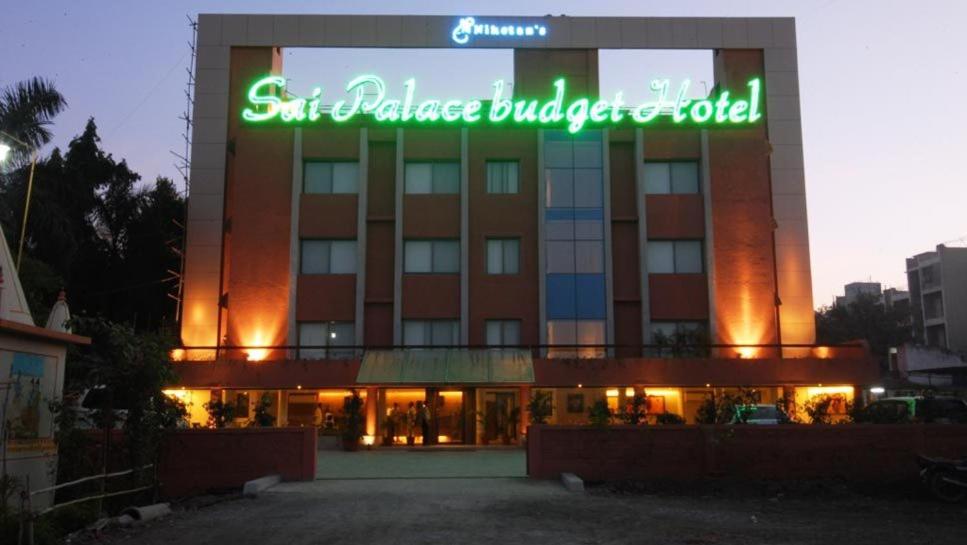 a building with a sign on the front of it at Sai Palace Budget Hotel in Shirdi