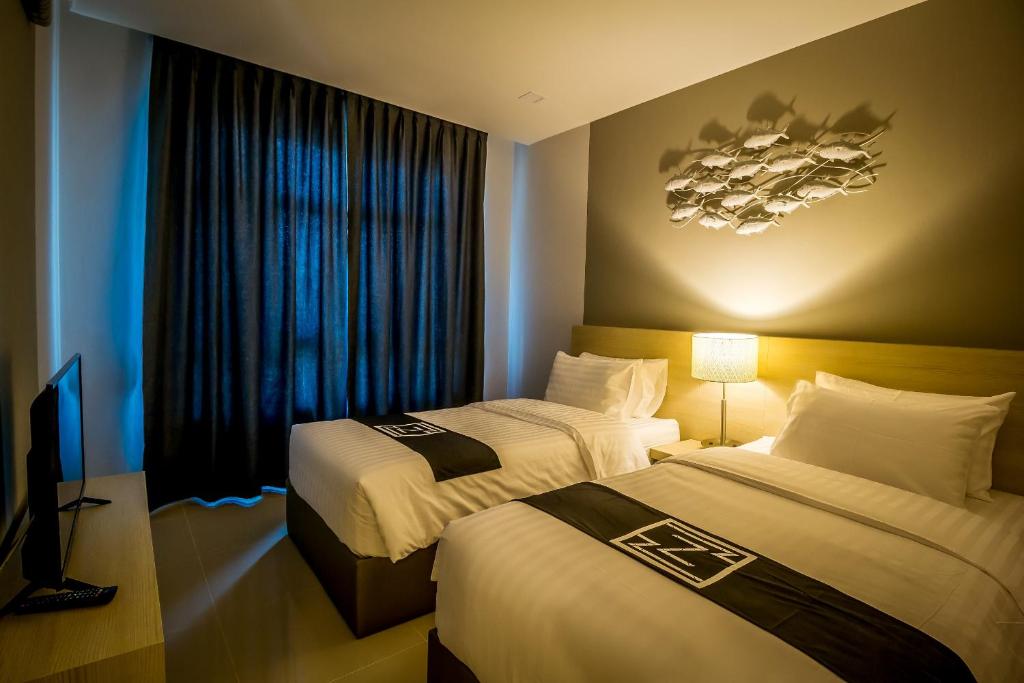 Postel nebo postele na pokoji v ubytování Triple Z Hotel