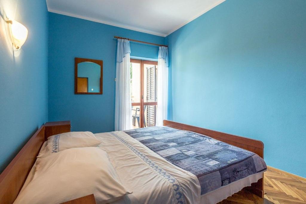 Postel nebo postele na pokoji v ubytování Apartments Vitomir