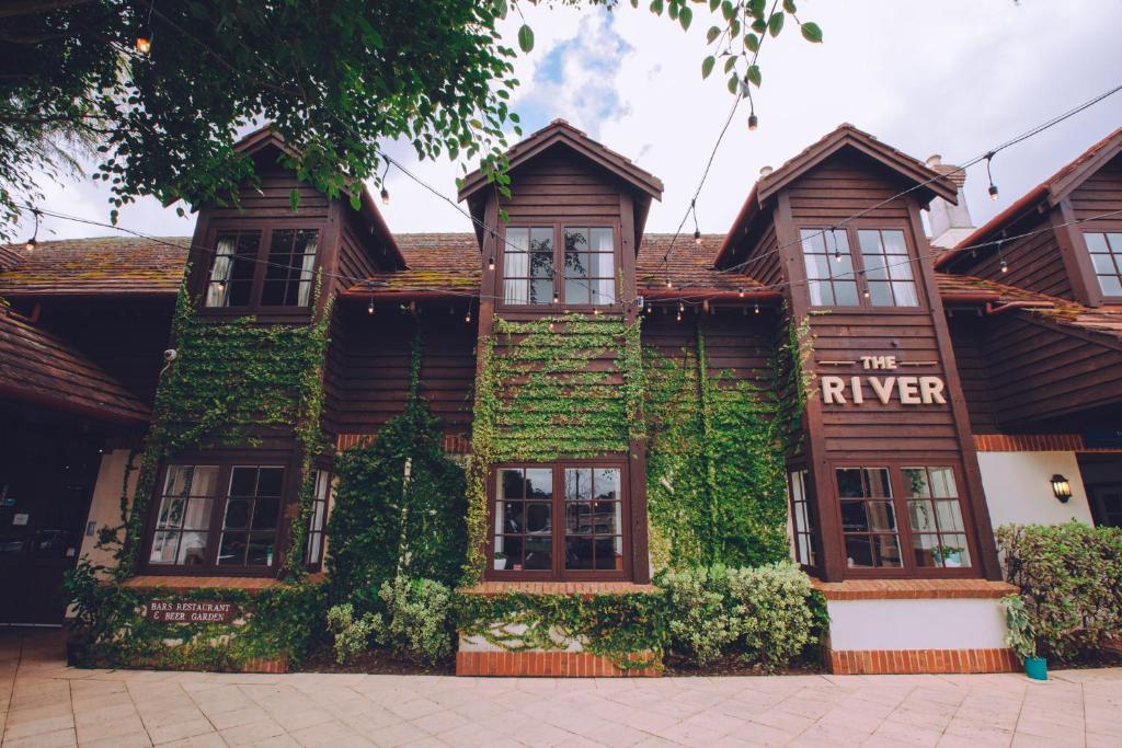 a building covered in green ivy with a sign on it at Margaret River Resort in Margaret River Town