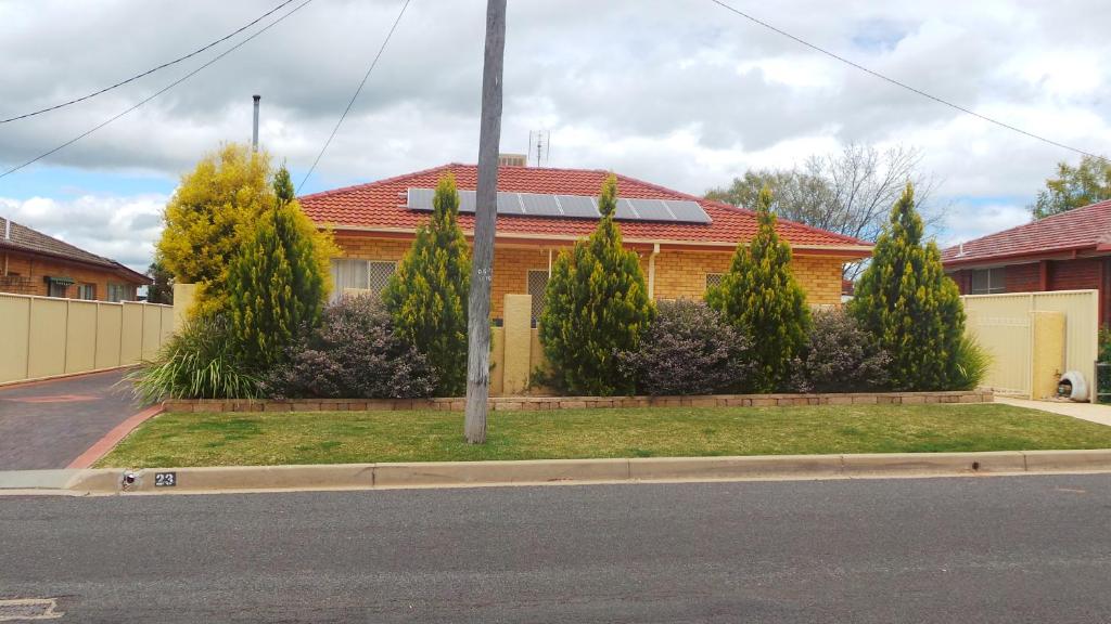 a house with trees in front of a street at Casa Bella in Tamworth