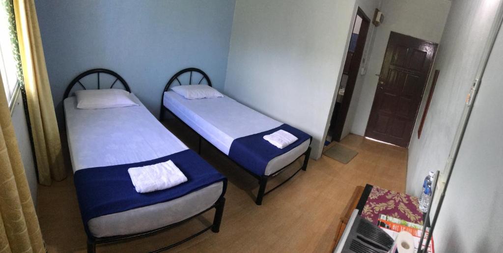 Postel nebo postele na pokoji v ubytování RTMS Guesthouse Semporna