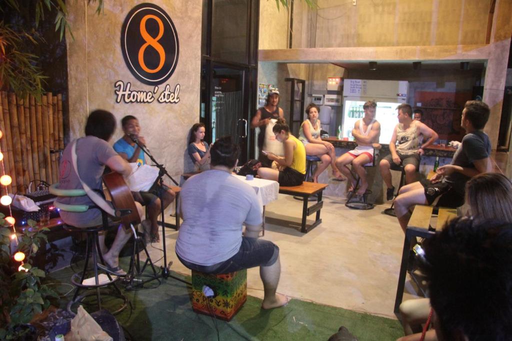 a group of people sitting in a room with a band at 8 homestel in Koh Tao