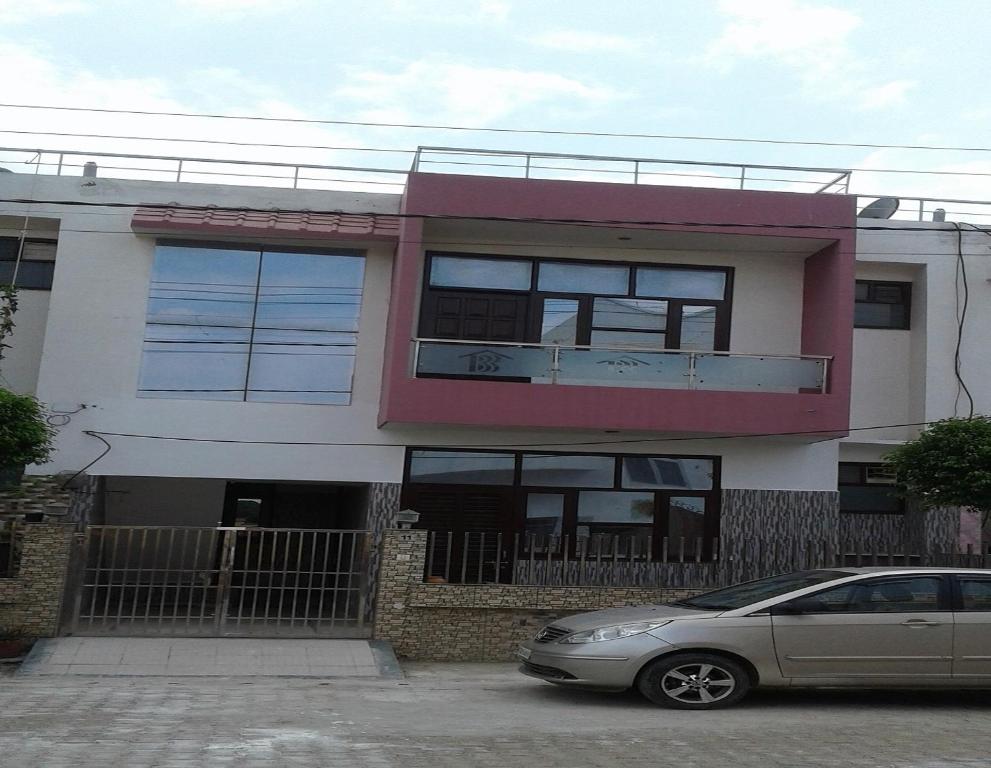 a house with a car parked in front of it at Paradise Villa in Vrindāvan