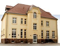 a large brick building with a brown roof at Hotel am Kulturplatz in Rastatt