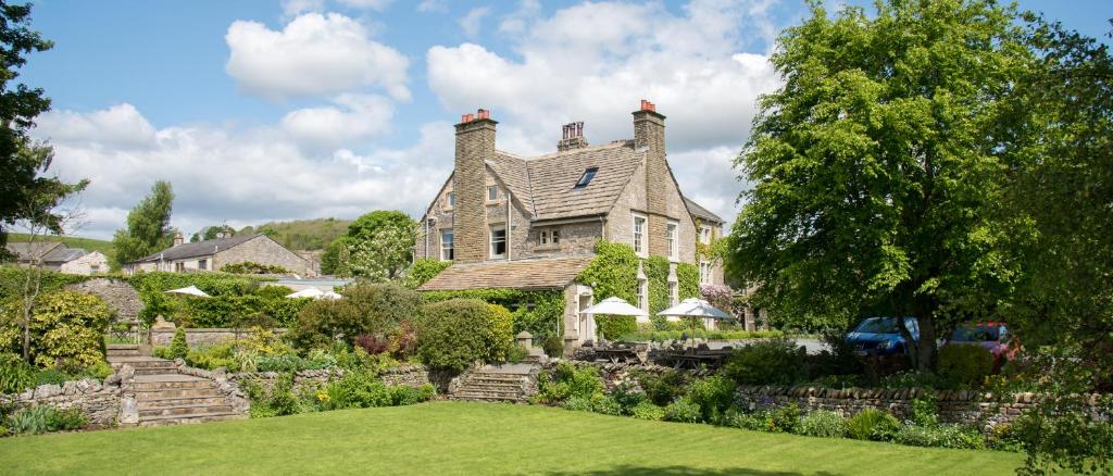 a large house with a garden in front of it at The Traddock in Austwick