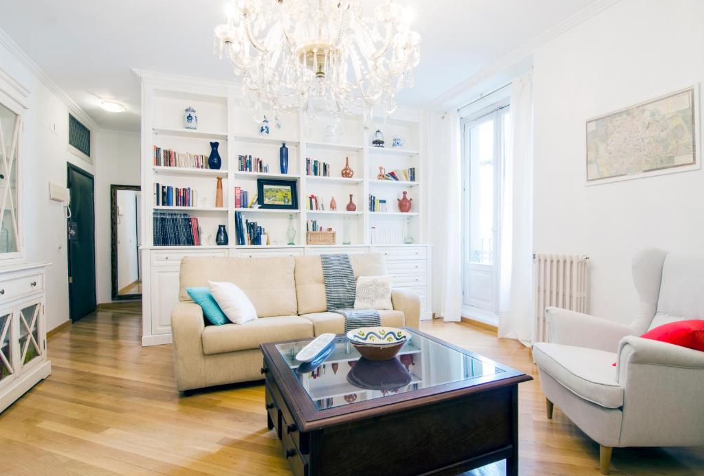 a living room with a couch and a chandelier at Imperial, 6 in Madrid