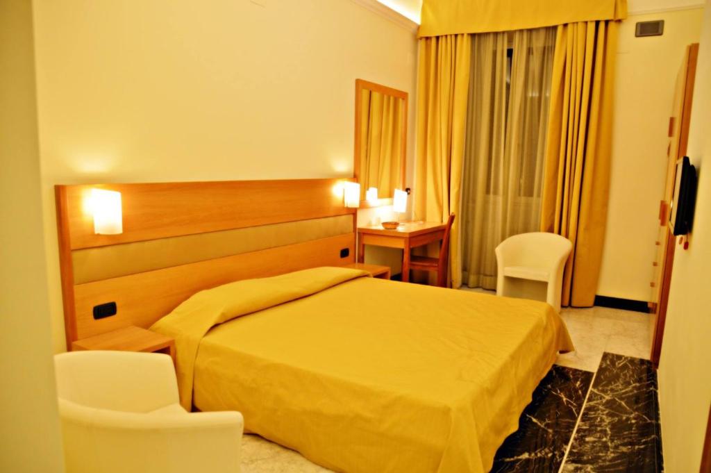 Postel nebo postele na pokoji v ubytování Hotel Moscatello