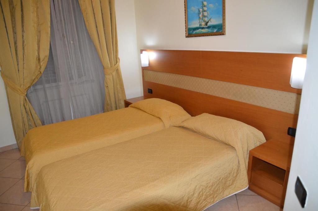 Postel nebo postele na pokoji v ubytování Hotel Moscatello