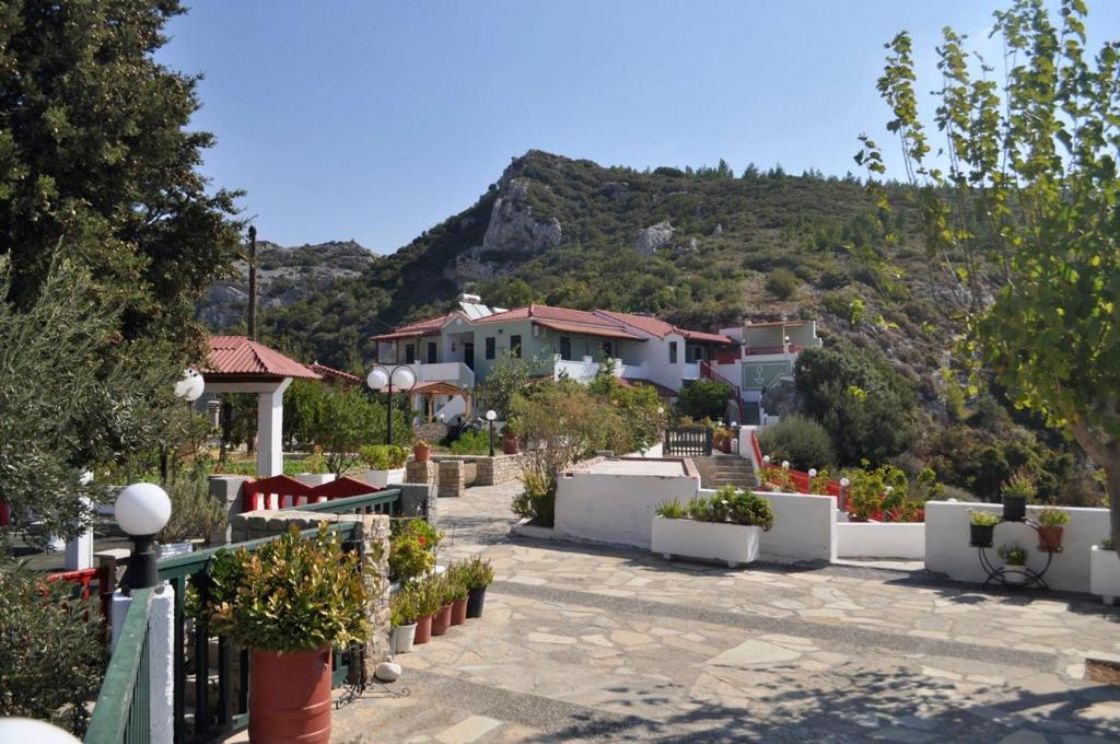 a row of houses with a mountain in the background at Katina Balos Rooms-Studios in Koumeika