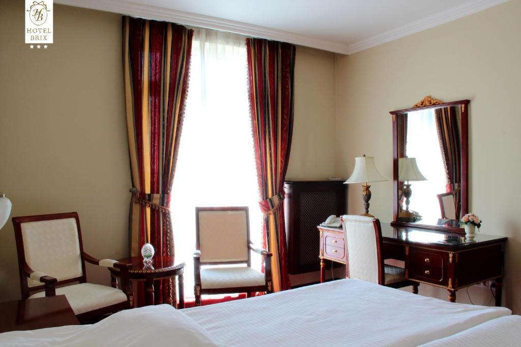 Postel nebo postele na pokoji v ubytování Luxury Garni Hotel Brix