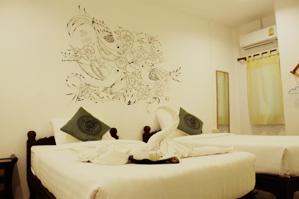 Postel nebo postele na pokoji v ubytování OldTown Boutique House Sukhothai