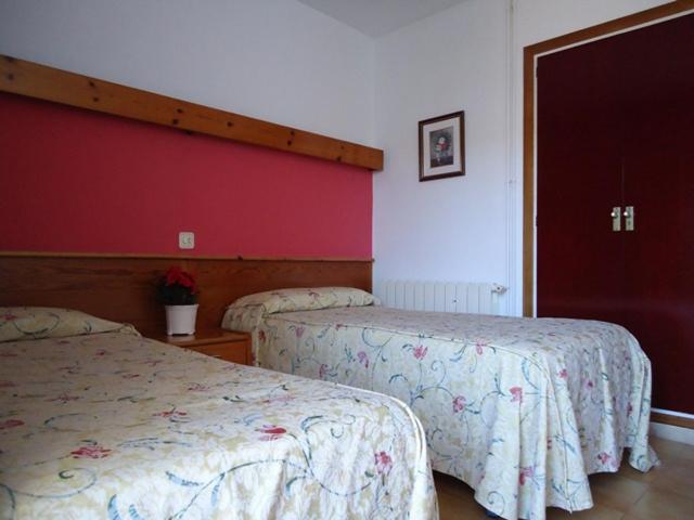 Postel nebo postele na pokoji v ubytování Hostal Magnolia