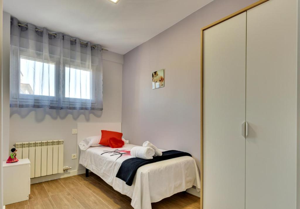 Postel nebo postele na pokoji v ubytování Apartamentos San Lázaro