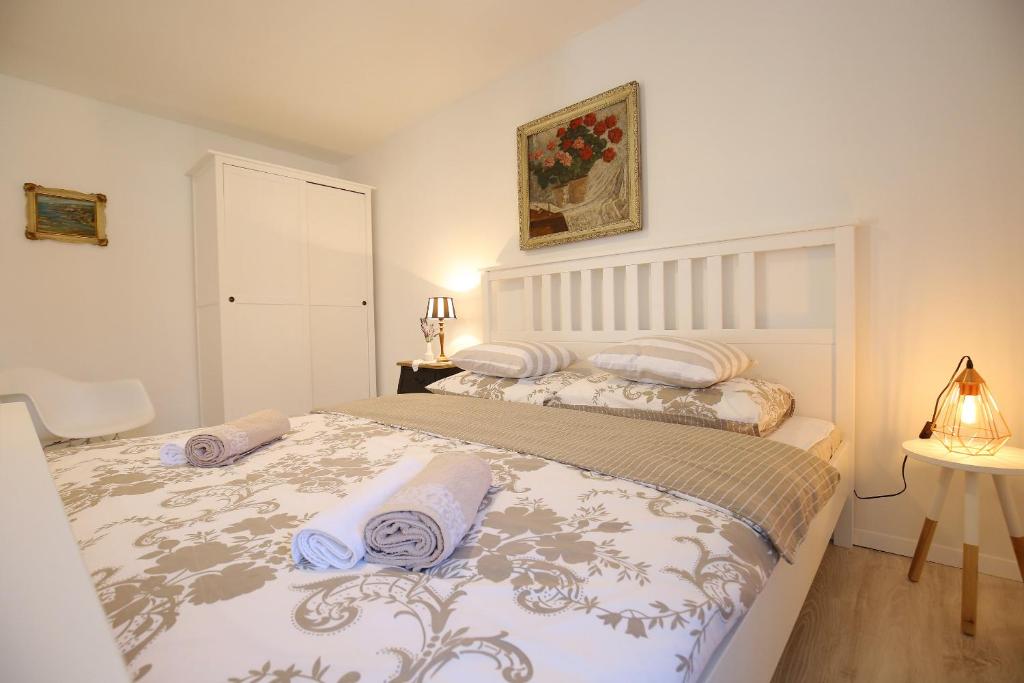 a bedroom with a bed with two pillows on it at The 2Sisters Suite in Zadar