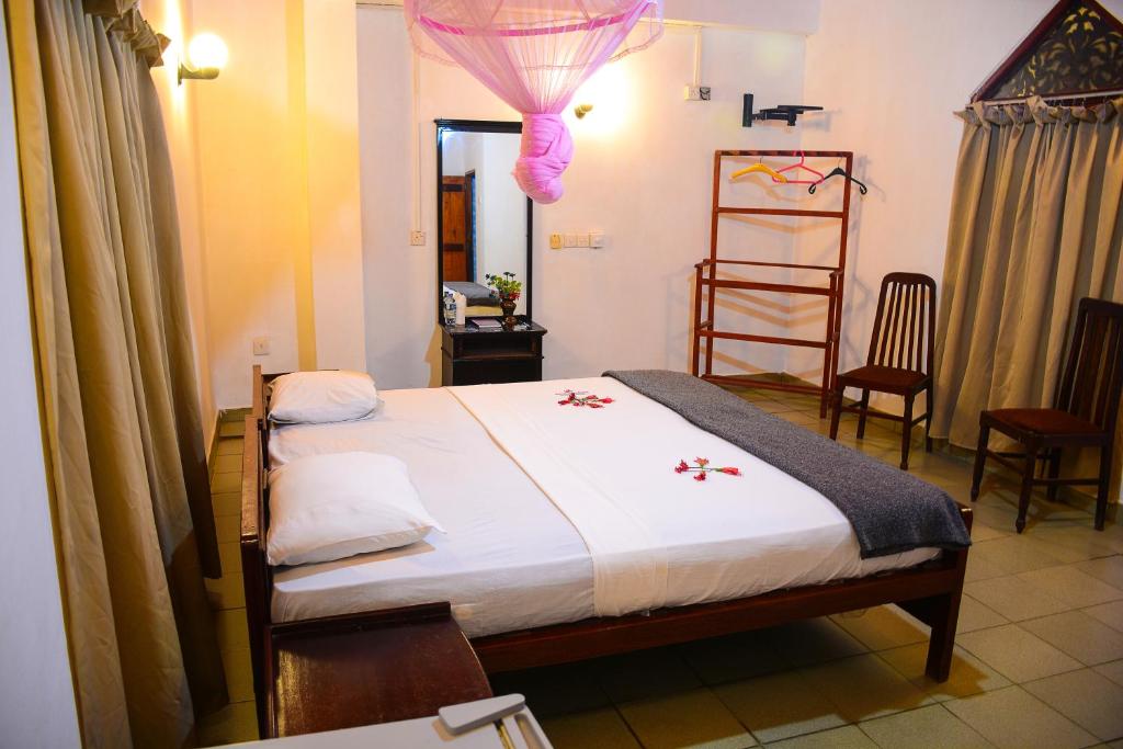 Postel nebo postele na pokoji v ubytování Shanthi Beach Resort