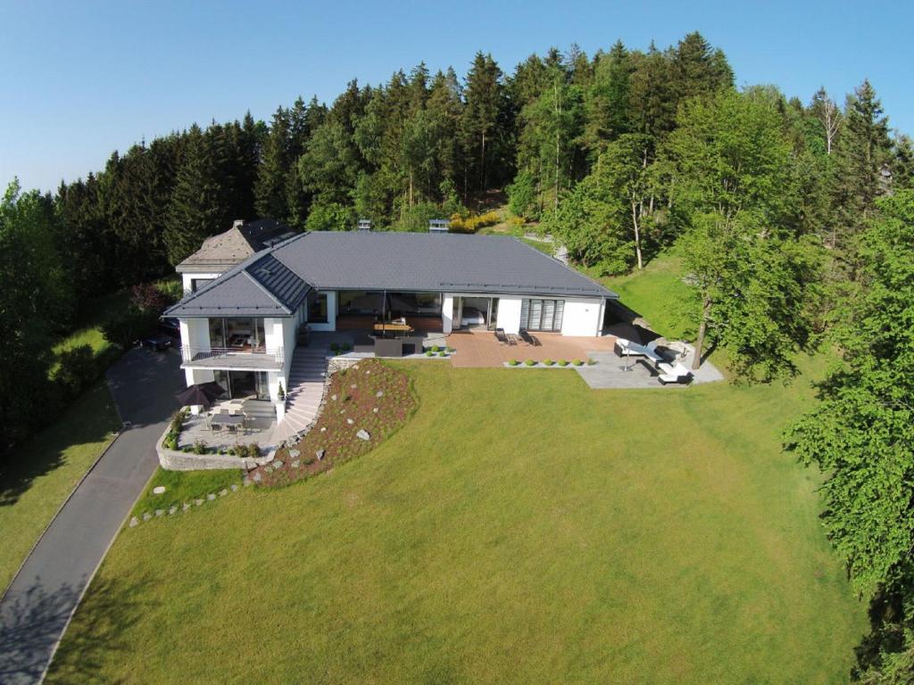 an aerial view of a house with a large yard at View & Garden Villa Schauenstein in Schauenstein