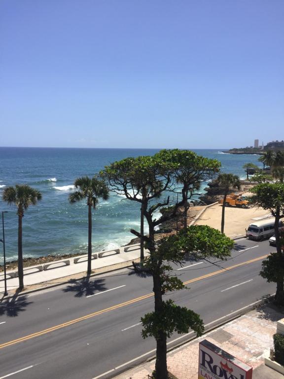 
a beach with palm trees and palm trees at Condo Villa Marbella in Santo Domingo
