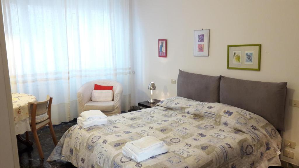 a bedroom with a bed and a chair at Pier Capponi Apartament in Florence