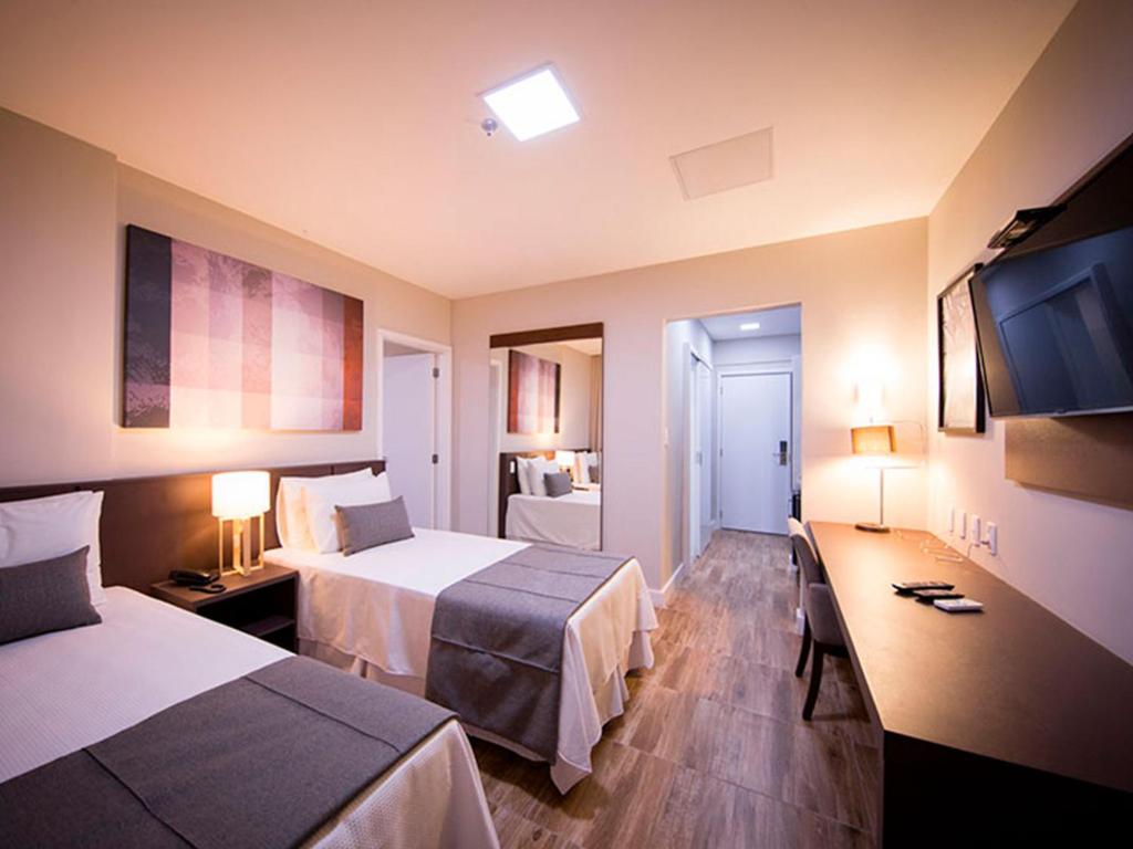 Säng eller sängar i ett rum på Vila Business Hotel