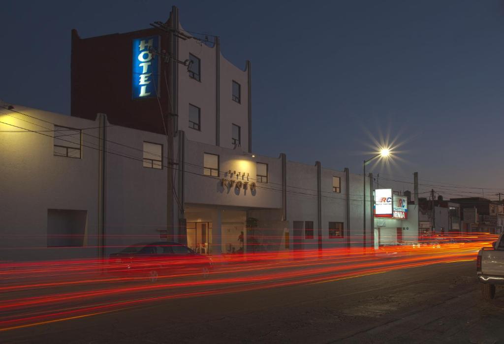 a building with a sign on the side of it at night at Hotel Kyoto in Puebla