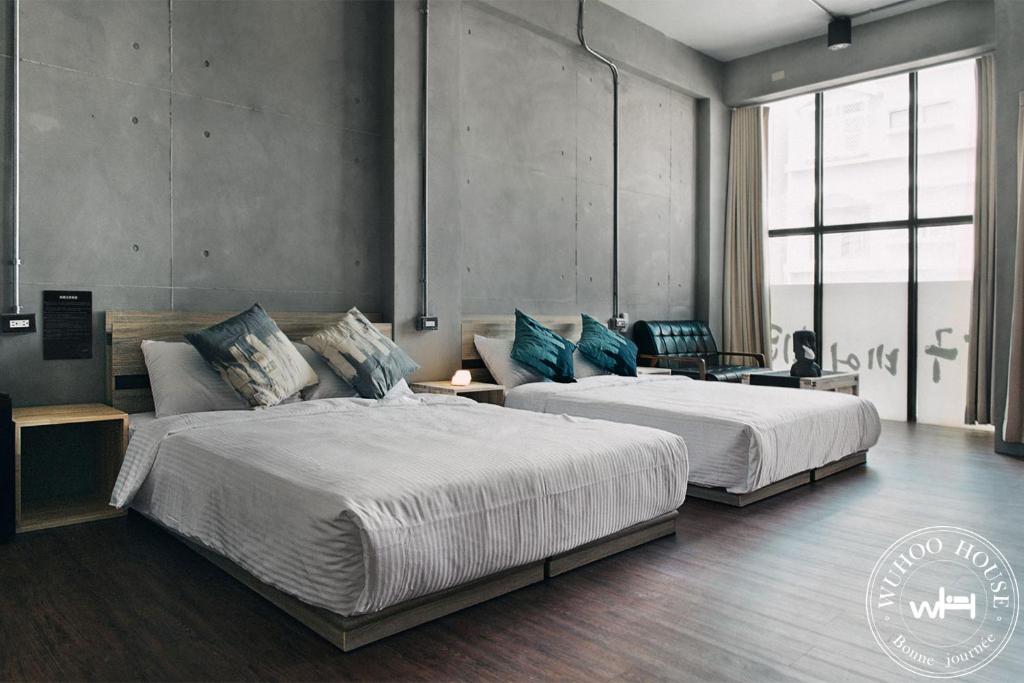 En eller flere senge i et værelse på Wuhoo House