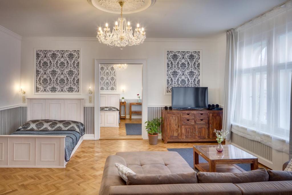 a living room with a couch and a tv at Veleslavinova 4 - Old Town Apartment in Prague