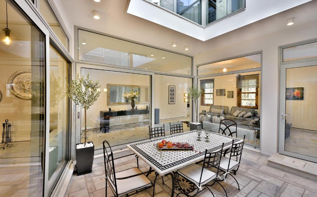 a dining room with a table and chairs at ALDIS MANSION by K&K in Athens