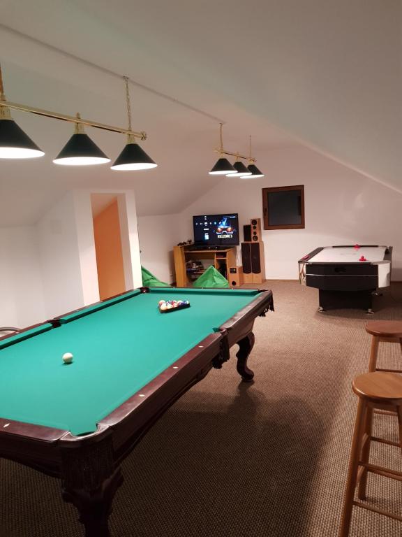 a billiard room with a pool table and a pool table at Vila Carmen in Cazaci