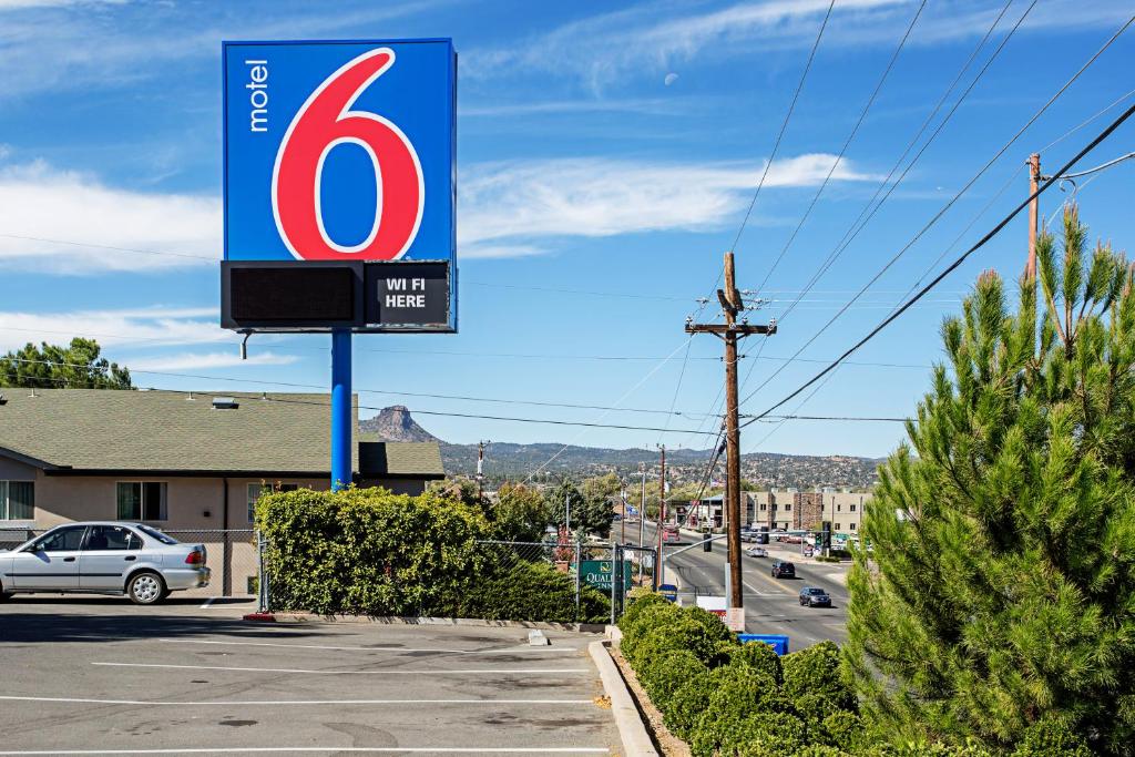 a sign for a gas station in a parking lot at Motel 6-Prescott, AZ in Prescott