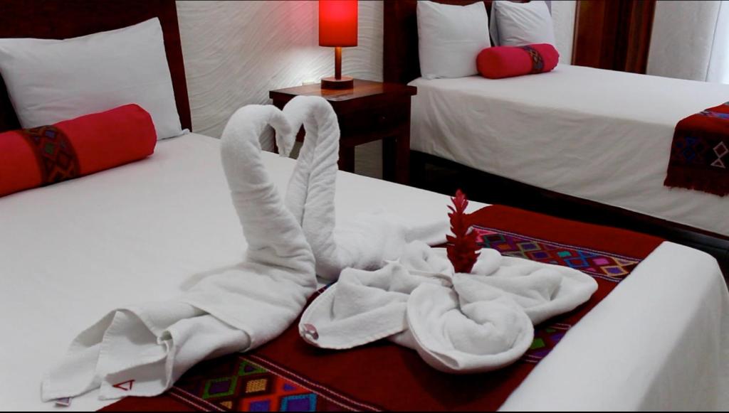 Postel nebo postele na pokoji v ubytování Hotel La Aldea del Halach Huinic