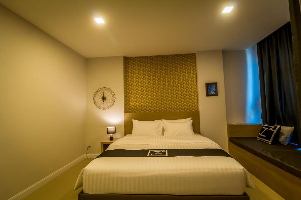 Postel nebo postele na pokoji v ubytování Triple Z Hotel