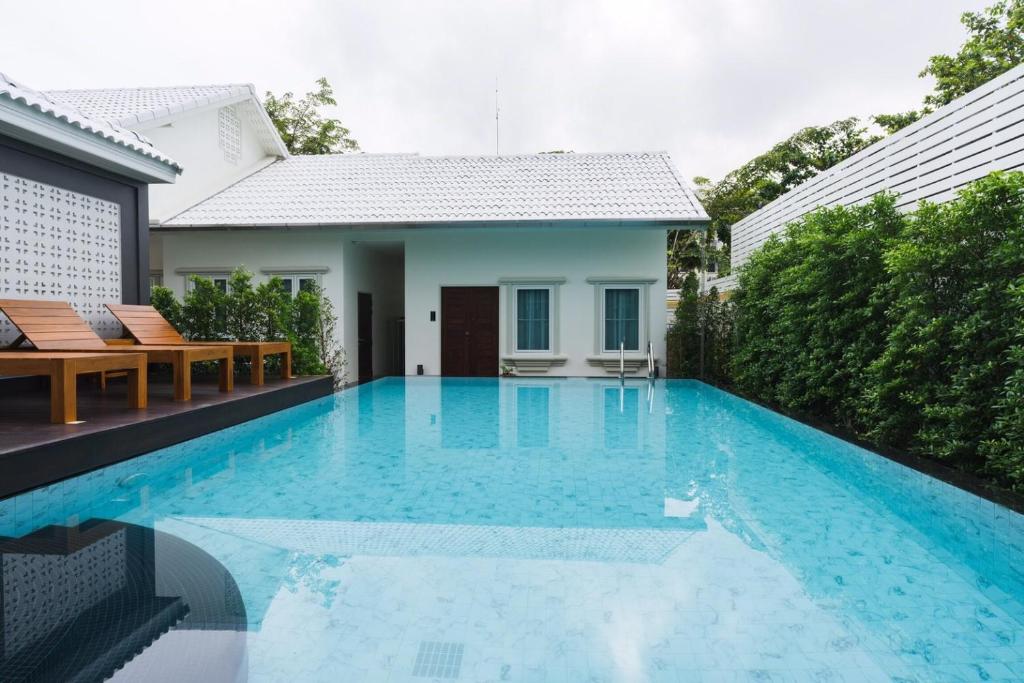 a swimming pool in the backyard of a house at The Besavana Phuket - SHA Extra Plus in Phuket Town