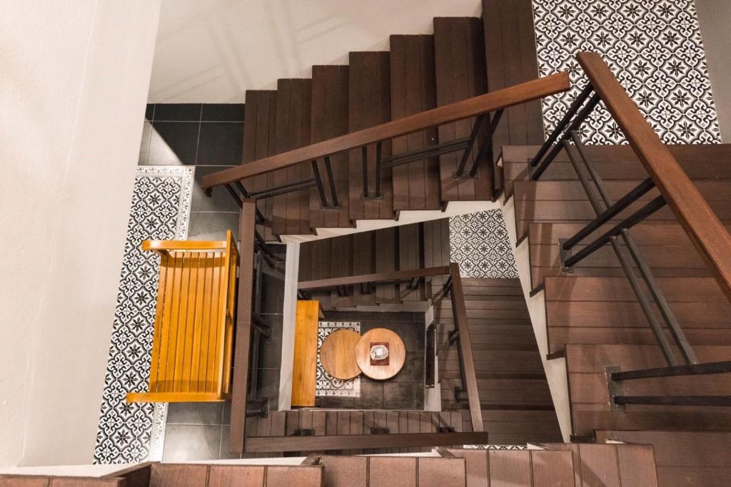 a view of a stairway with a wooden railing at The Besavana Phuket - SHA Extra Plus in Phuket Town