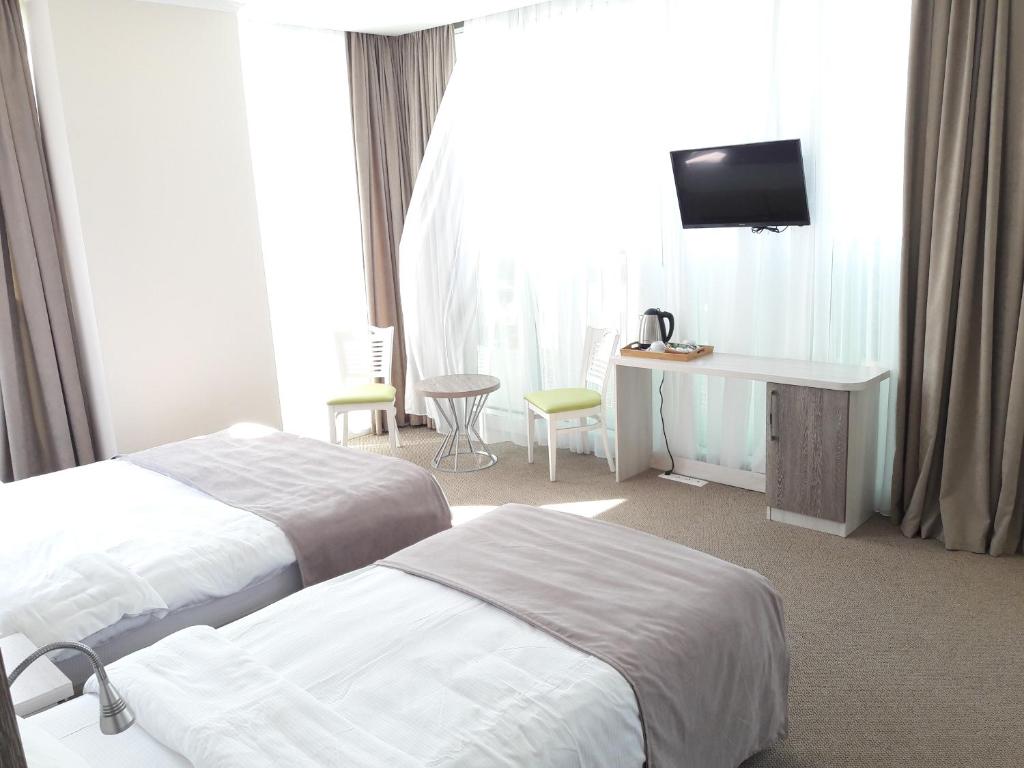 Postel nebo postele na pokoji v ubytování Hotel Green Glass