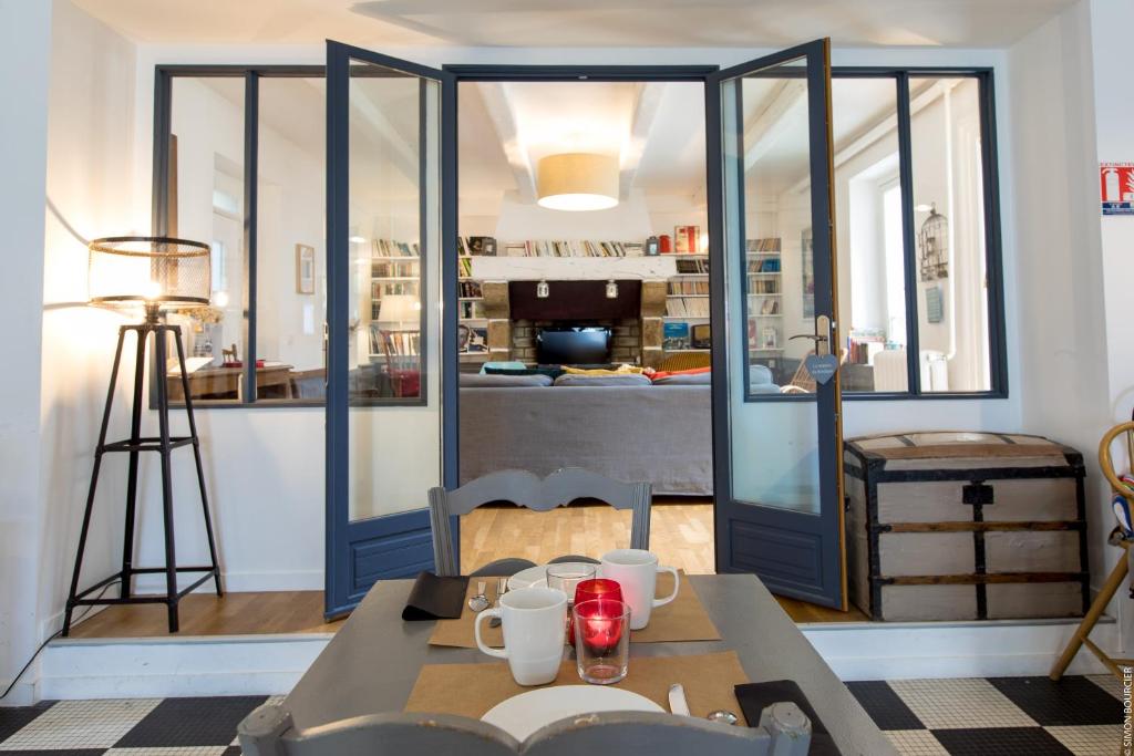 a dining room with a table and a kitchen at Hotel Saint-Michel in Dinard