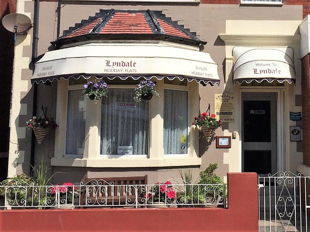 a building with a balcony with flowers on it at Lyndale Holiday Flats in Blackpool