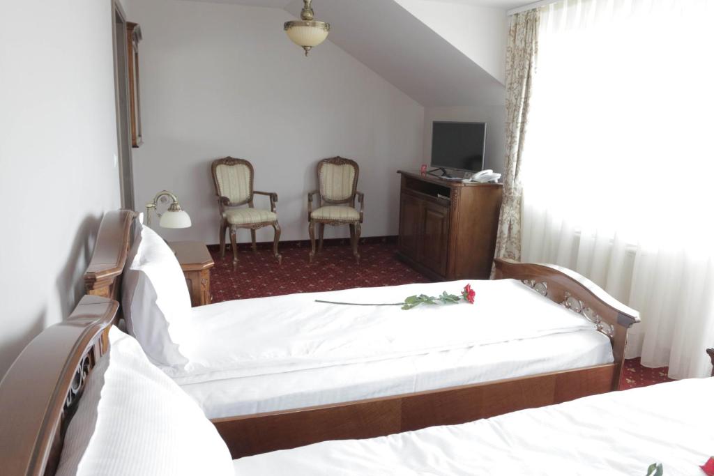 Postel nebo postele na pokoji v ubytování Hotel Slavia
