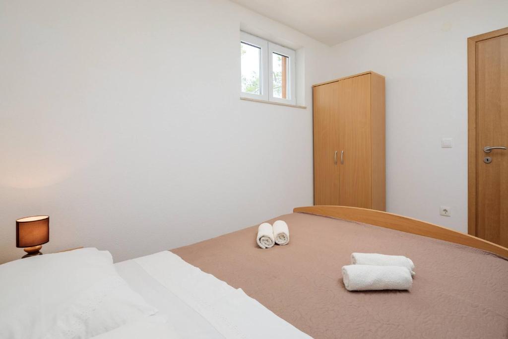 Postel nebo postele na pokoji v ubytování Pavao Apartments