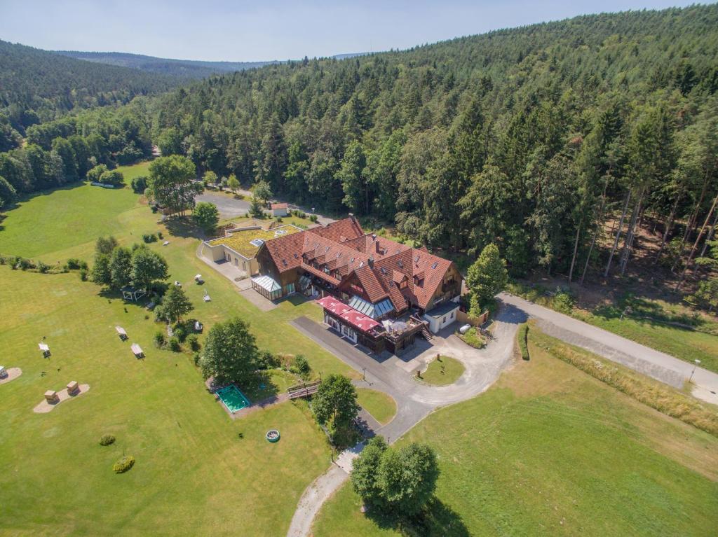 eine Luftansicht eines großen Hauses auf einem Feld in der Unterkunft Hotel Im Krummbachtal in Schönau an der Brend