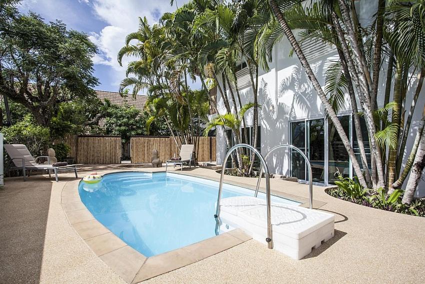 a swimming pool in front of a house with palm trees at ViLLa JUNGLE 3 BEDROOMS in Kamala Beach