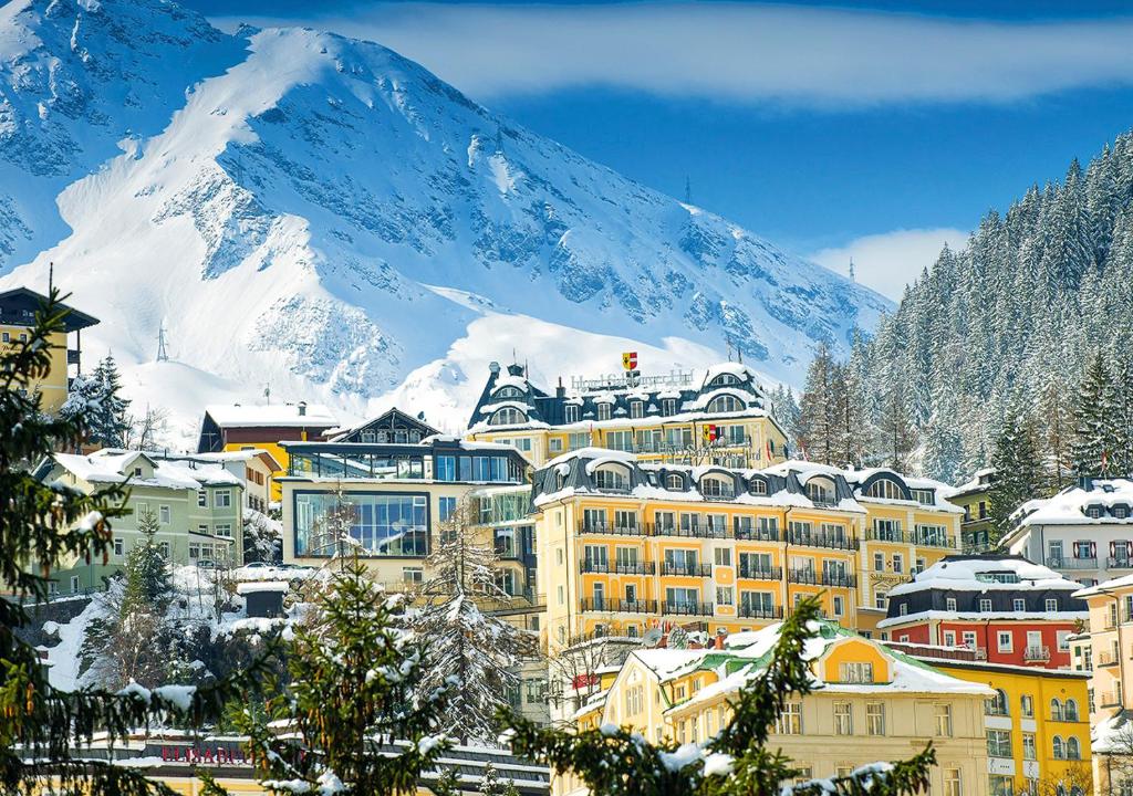 une ville avec une montagne enneigée en arrière-plan dans l'établissement Hotel Salzburger Hof, à Bad Gastein