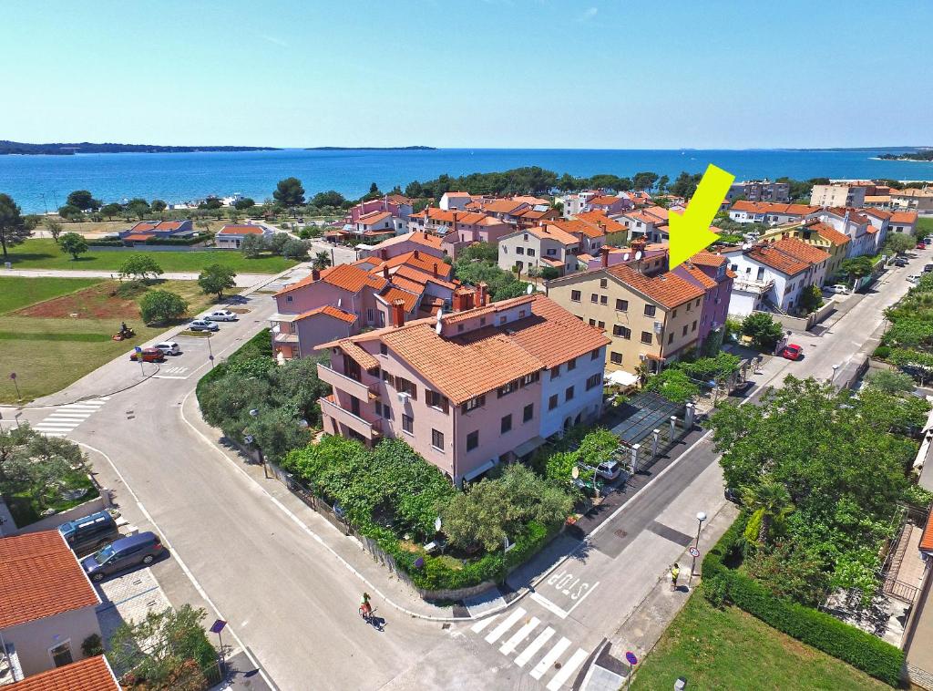 an aerial view of a city with houses and the ocean at Apartments Stana 242 in Fažana