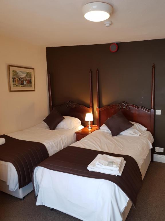 Postel nebo postele na pokoji v ubytování Old George Hotel
