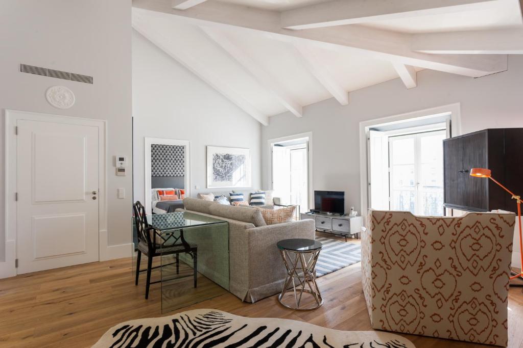 a living room with a couch and a table at FLH Restauradores Amazing Flat with View in Lisbon