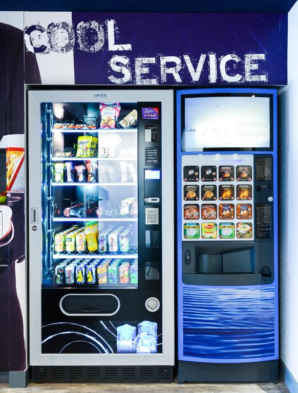 a large refrigerator with its door open with food inside at Ibis Budget Salzburg Airport - Self-Check-In in Salzburg